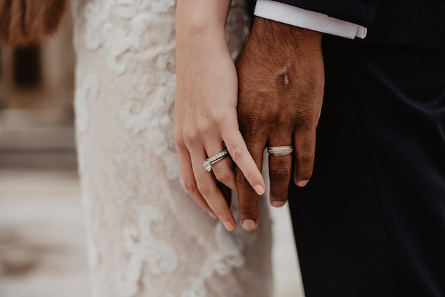 two-persons-wearing-silver-colored-rings