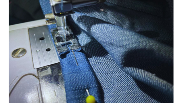Create a rolled hem to finish the gathered dress